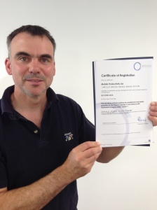 Tom proudly displays ISO 27001:2013 Certificate of Registration